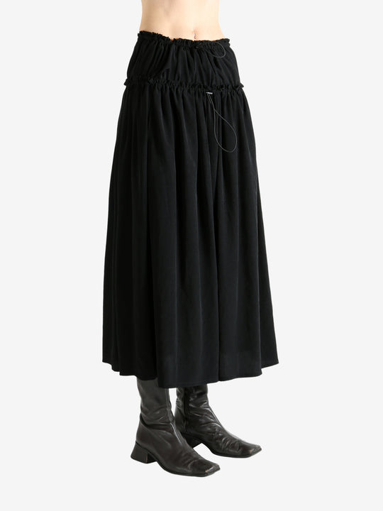 Black skirt worn by a person, showing the skirt fit
