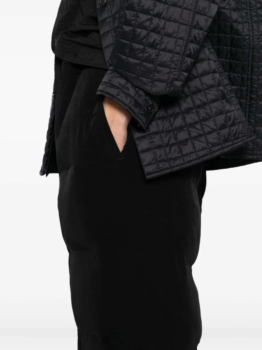 Close up of black pants, showing texture of the triacetate and polyester fabric