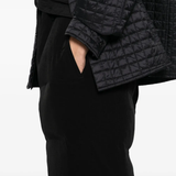 Close up of black pants, showing texture of the triacetate and polyester fabric