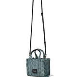 Close up of blue bag, showing texture of handbag with a strap 