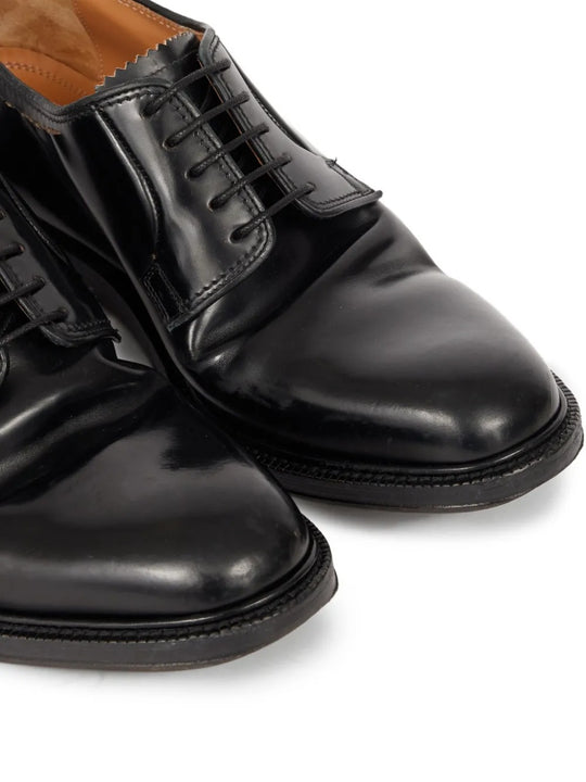 Close up of black shoes, showing texture of the leather fabric