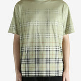 green t-shirt worn by a person, showing the t-shirt fit