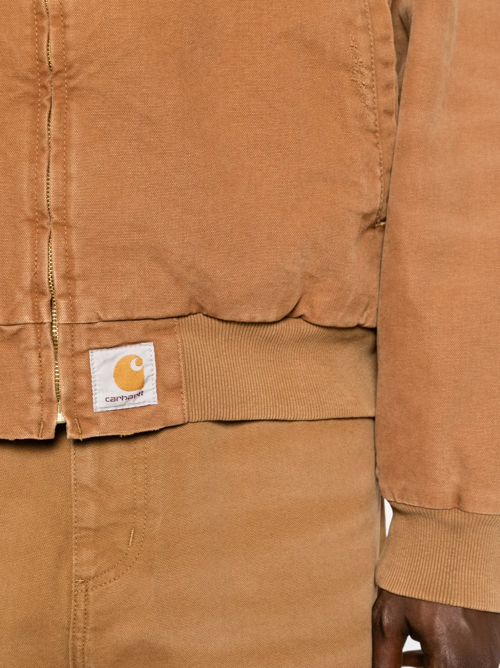 close up of brown jackets-coats, showing texture of the cotton fabric