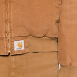 close up of brown jackets-coats, showing texture of the cotton fabric