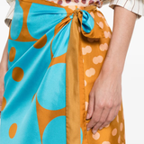 close up of orange skirts , showing texture of the silk fabric