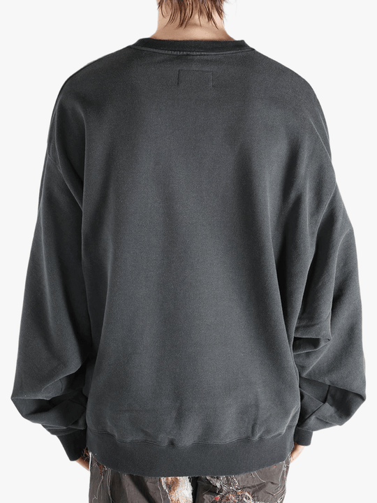 Black shirt worn by a person, showing the shirt's fit