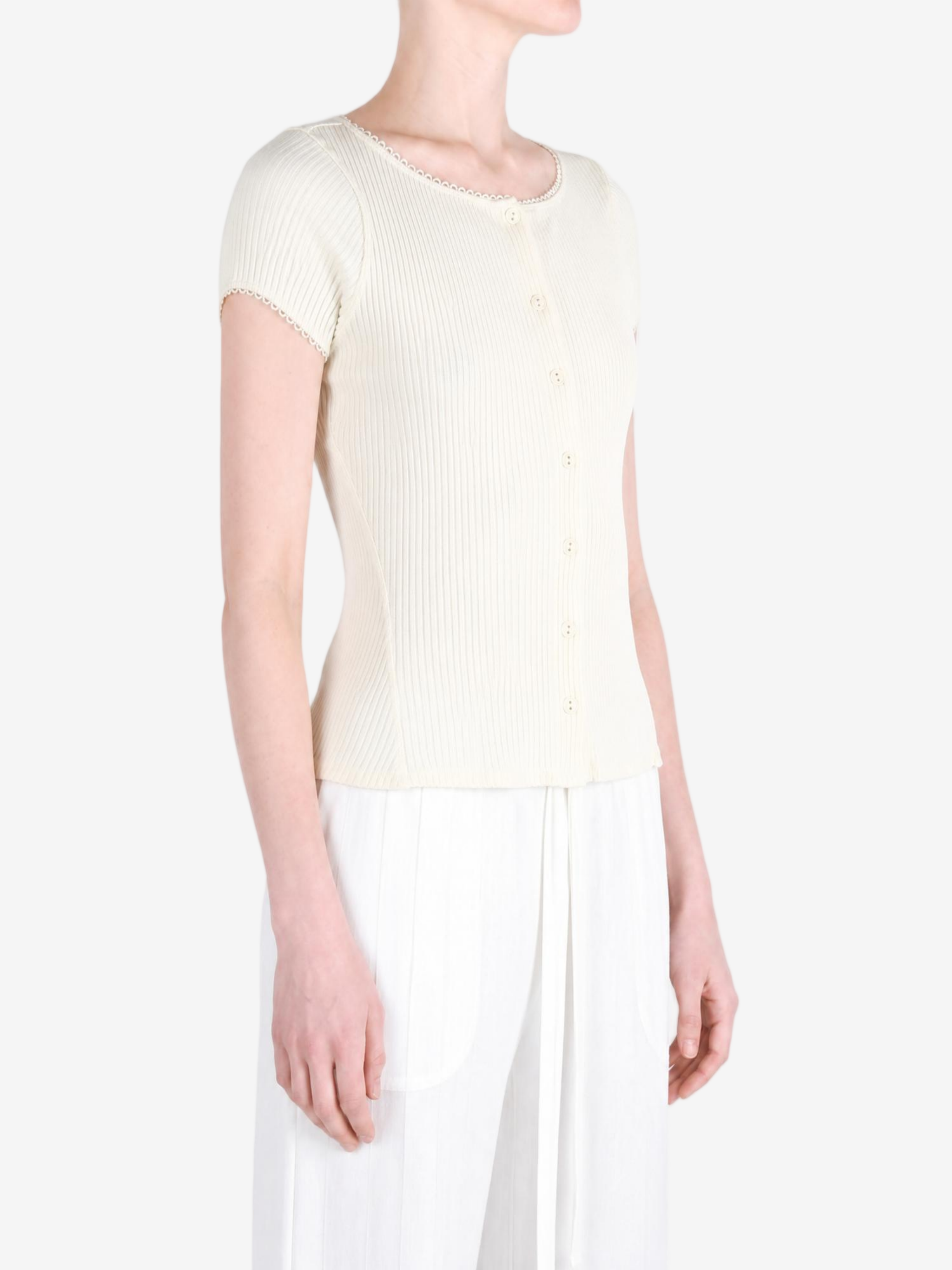 Tan knitwear worn by a person, showing the knitwear fit