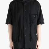 Black shirt worn by a person, showing the shirt's fit