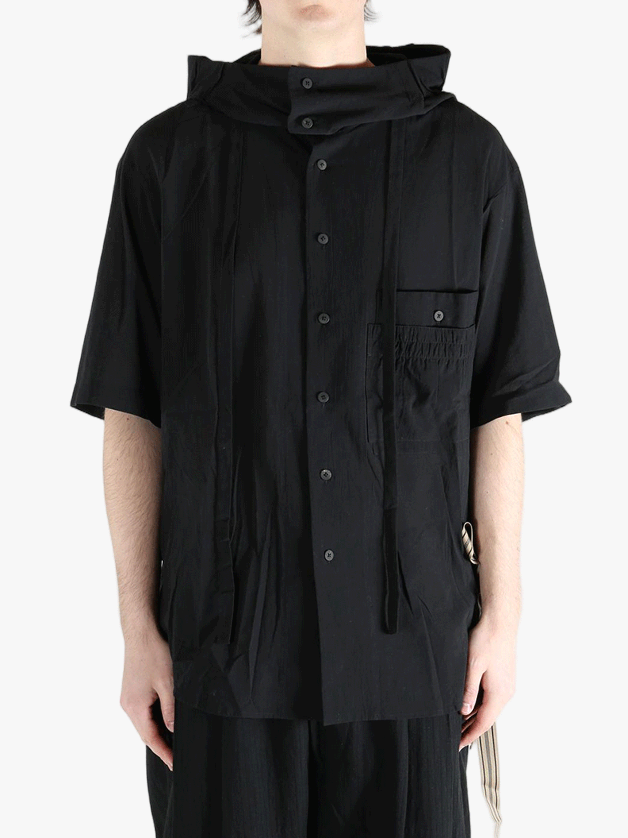 Black shirt worn by a person, showing the shirt's fit