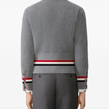 Grey knitwear worn by a person, showing the knitwear fit