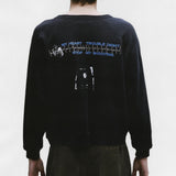 Black sweatshirt worn by a person, showing the sweatshirt's fit