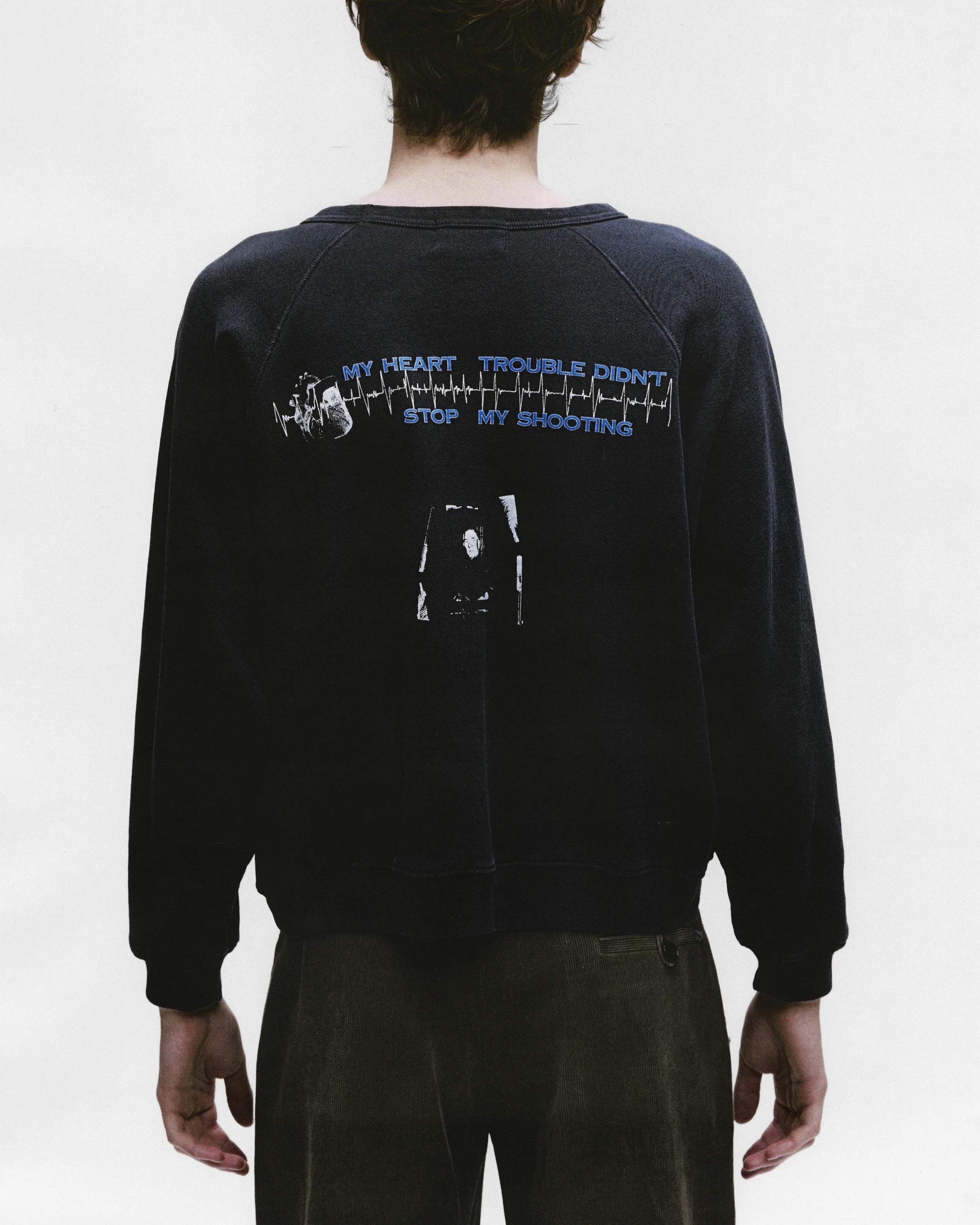 Black sweatshirt worn by a person, showing the sweatshirt's fit