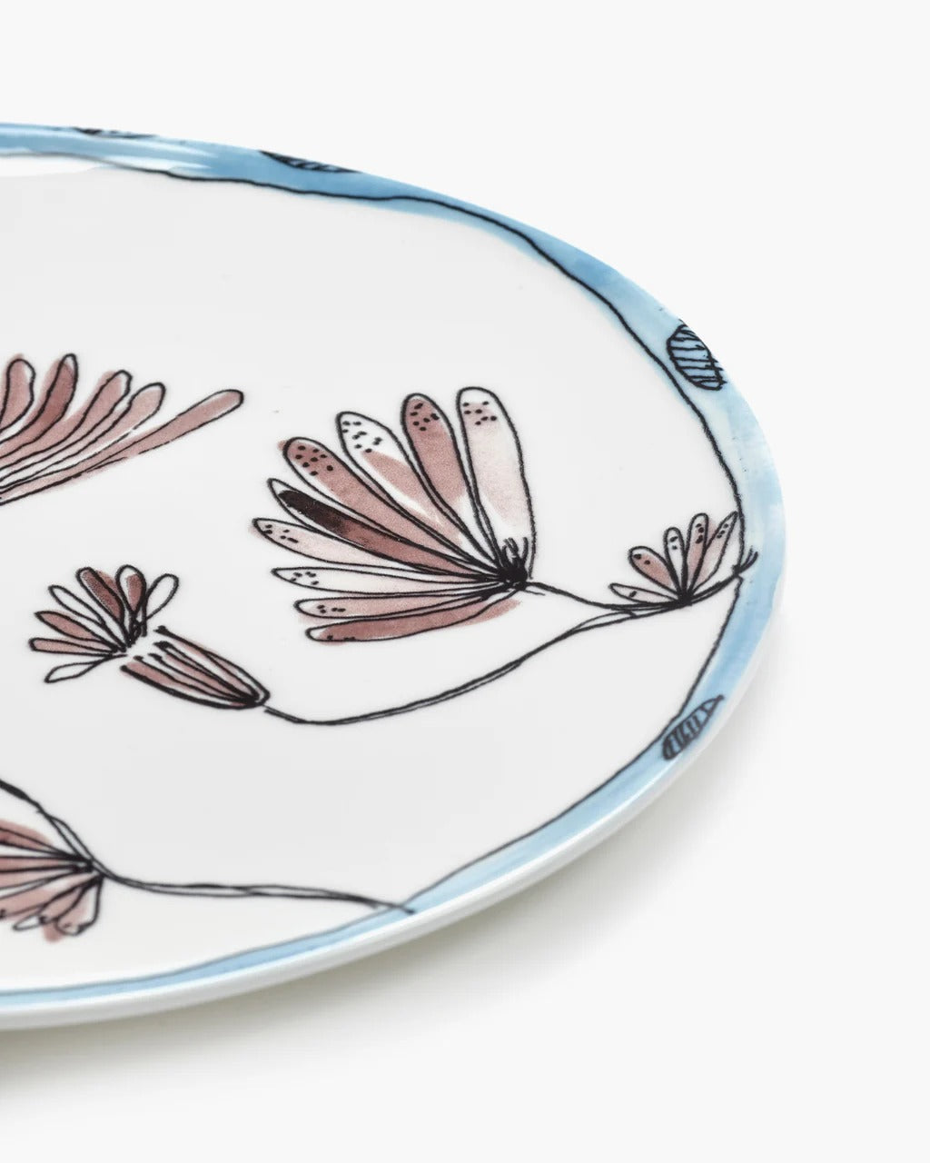 Close up of blue plate, showing texture of the bone porcelain fabric