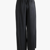 Black pants worn by a person, showing the pants fit