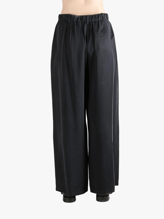 Black pants worn by a person, showing the pants fit