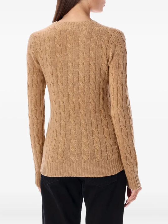 Brown knitwear worn by a person, showing the knitwear's fit