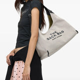 White bag worn by a person, showing the bag's fit