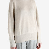 Grey knitwear worn by a person, showing the knitwear fit