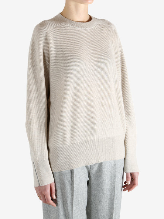 Grey knitwear worn by a person, showing the knitwear fit