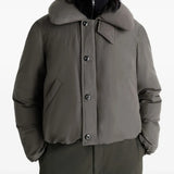 Grey coat worn by a person, showing the coat's fit