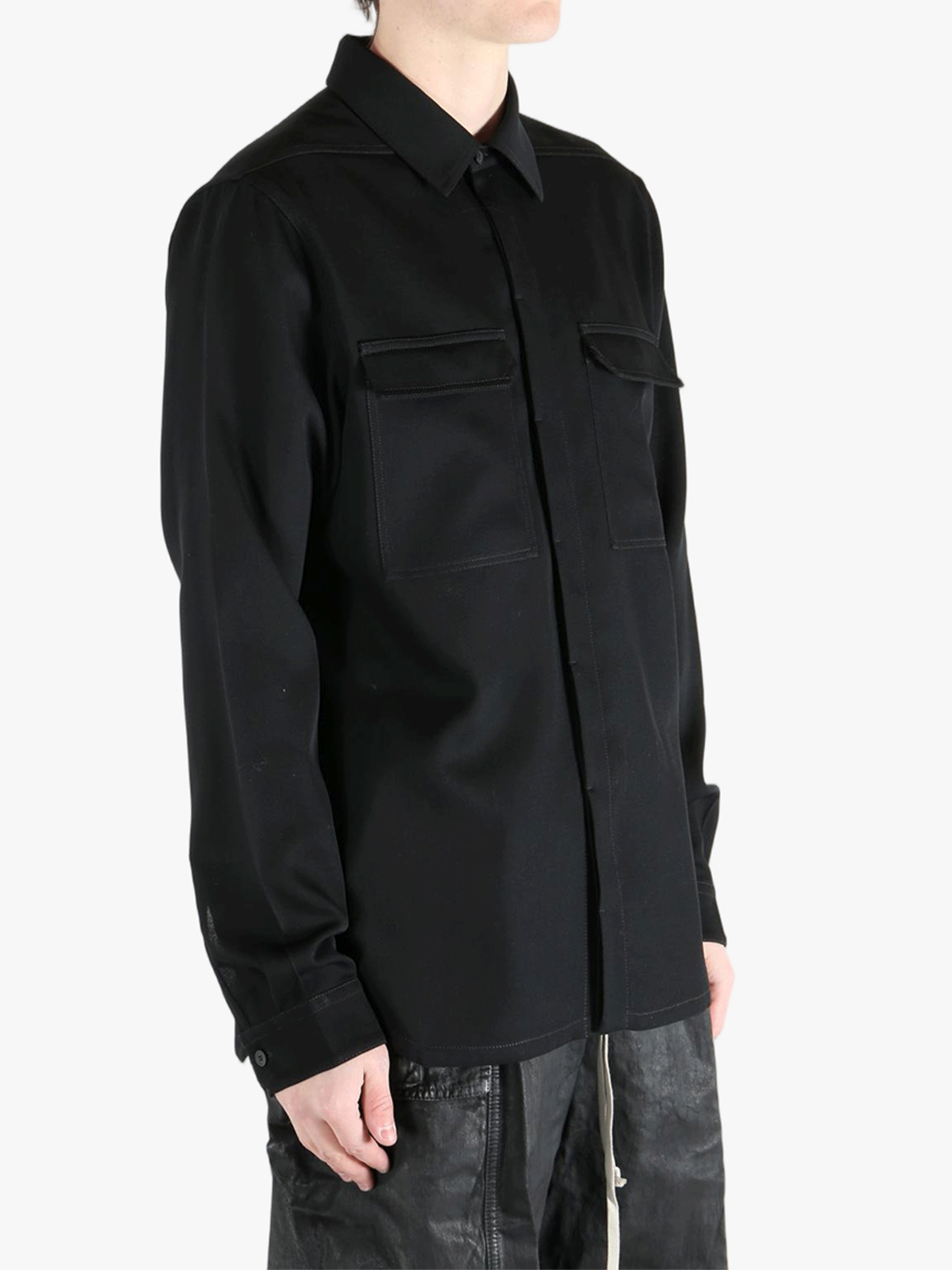 Black shirts worn by a person, showing the shirts fit