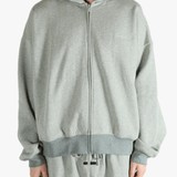 Gray zip-up hoodie worn by a person, showing the hoodie fit