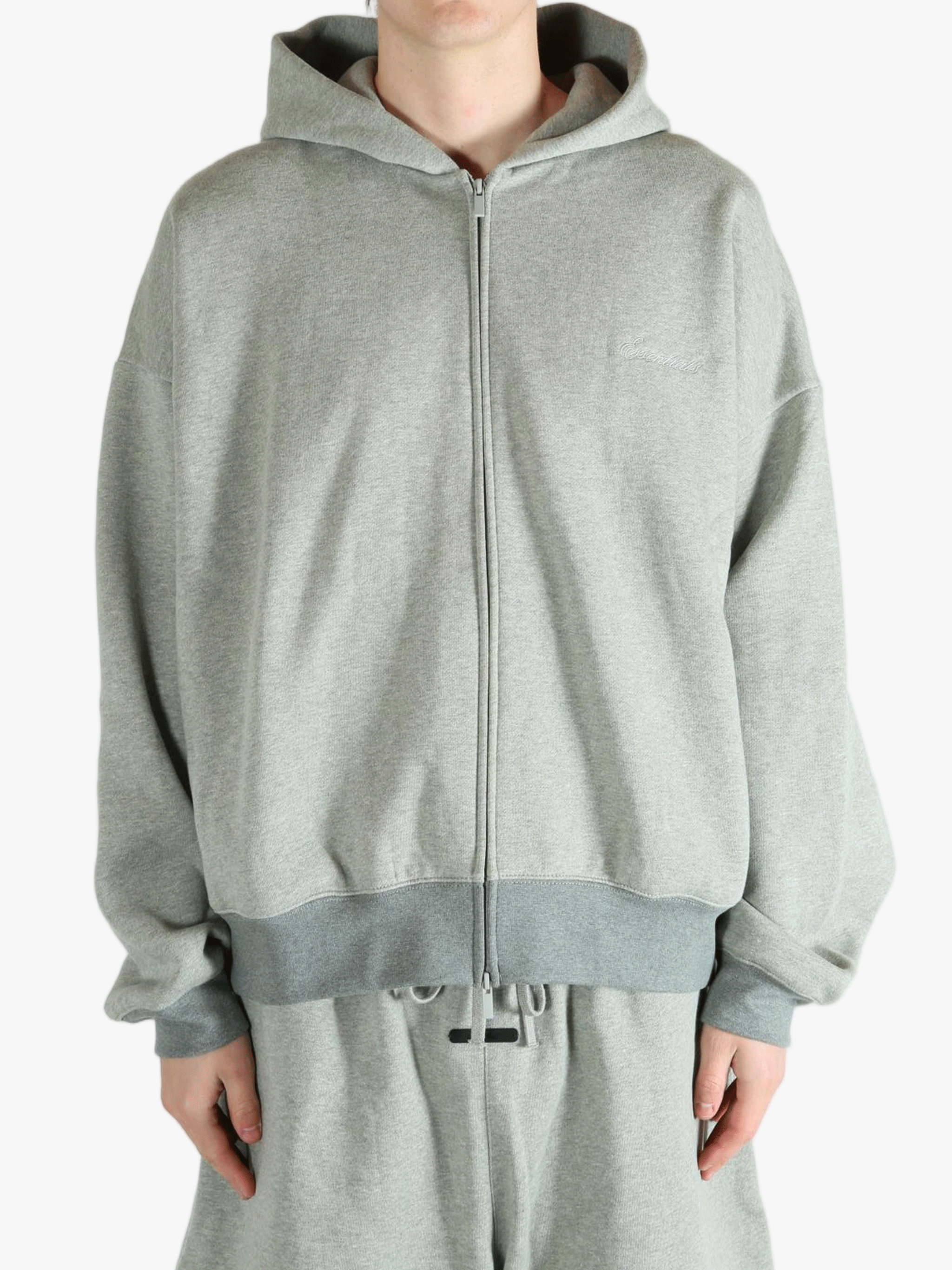 Gray zip-up hoodie worn by a person, showing the hoodie fit