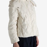 White jacket worn by a person, showing the jacket's fit