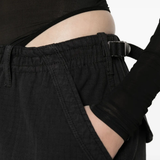 Close up of black pants, showing texture of the cotton fabric