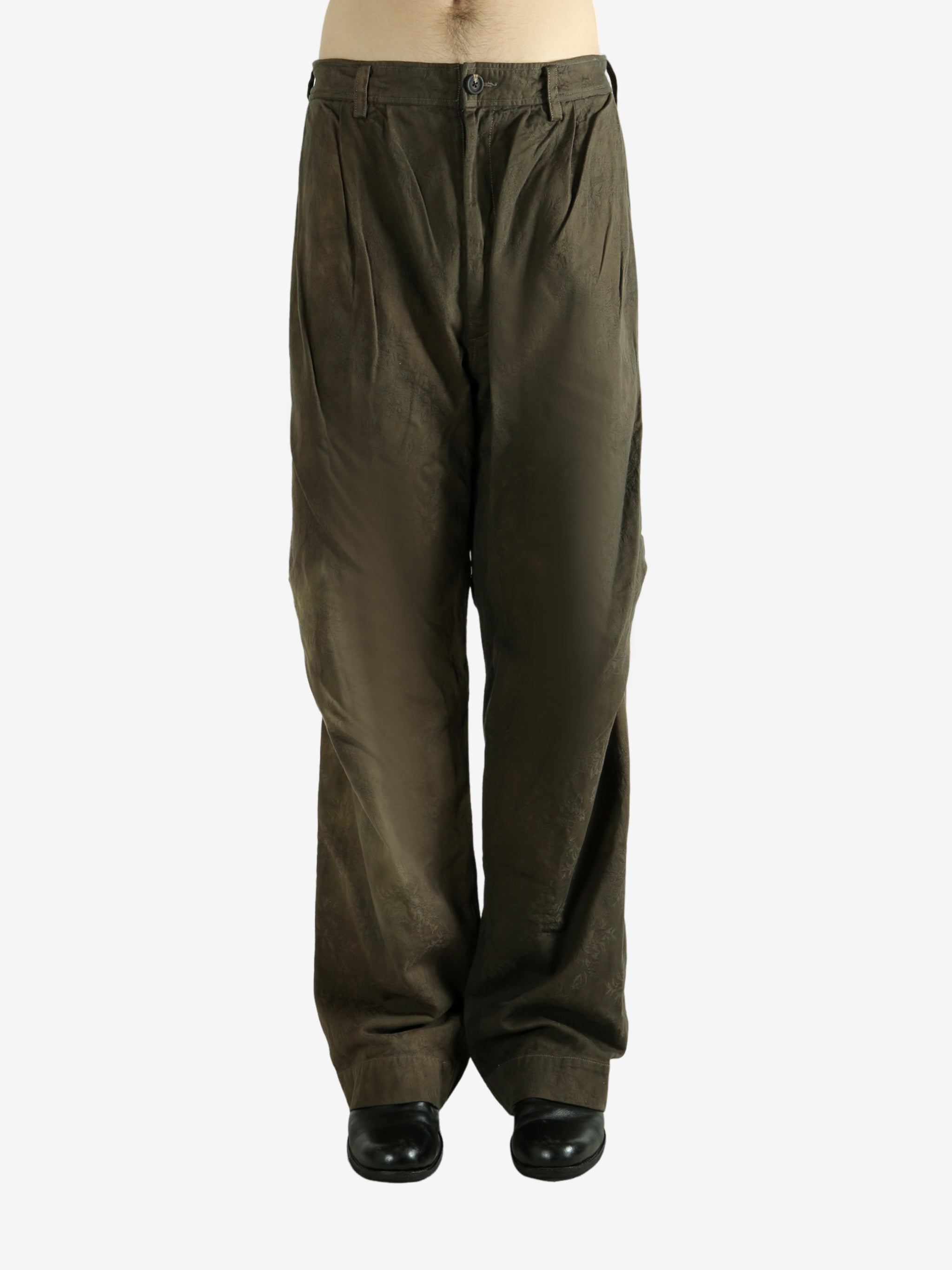 Green pants worn by a person, showing the pants fit