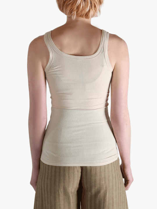 White top worn by a person, showing the top's fit