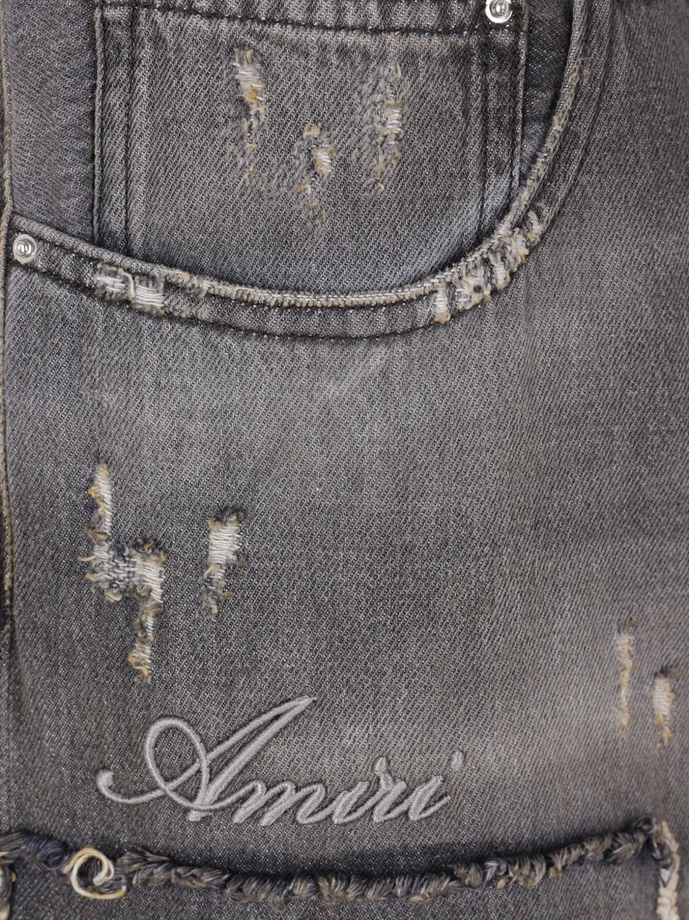Close up of the balck jeans, showing texture of the cotton fabric