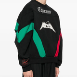 Black knitwears worn by a person, showing the knitwears fit