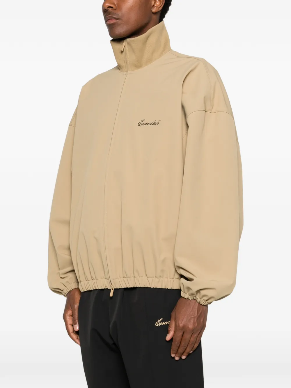 Tan coats worn by a person, showing the coats fit