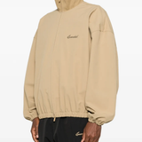 Tan coats worn by a person, showing the coats fit