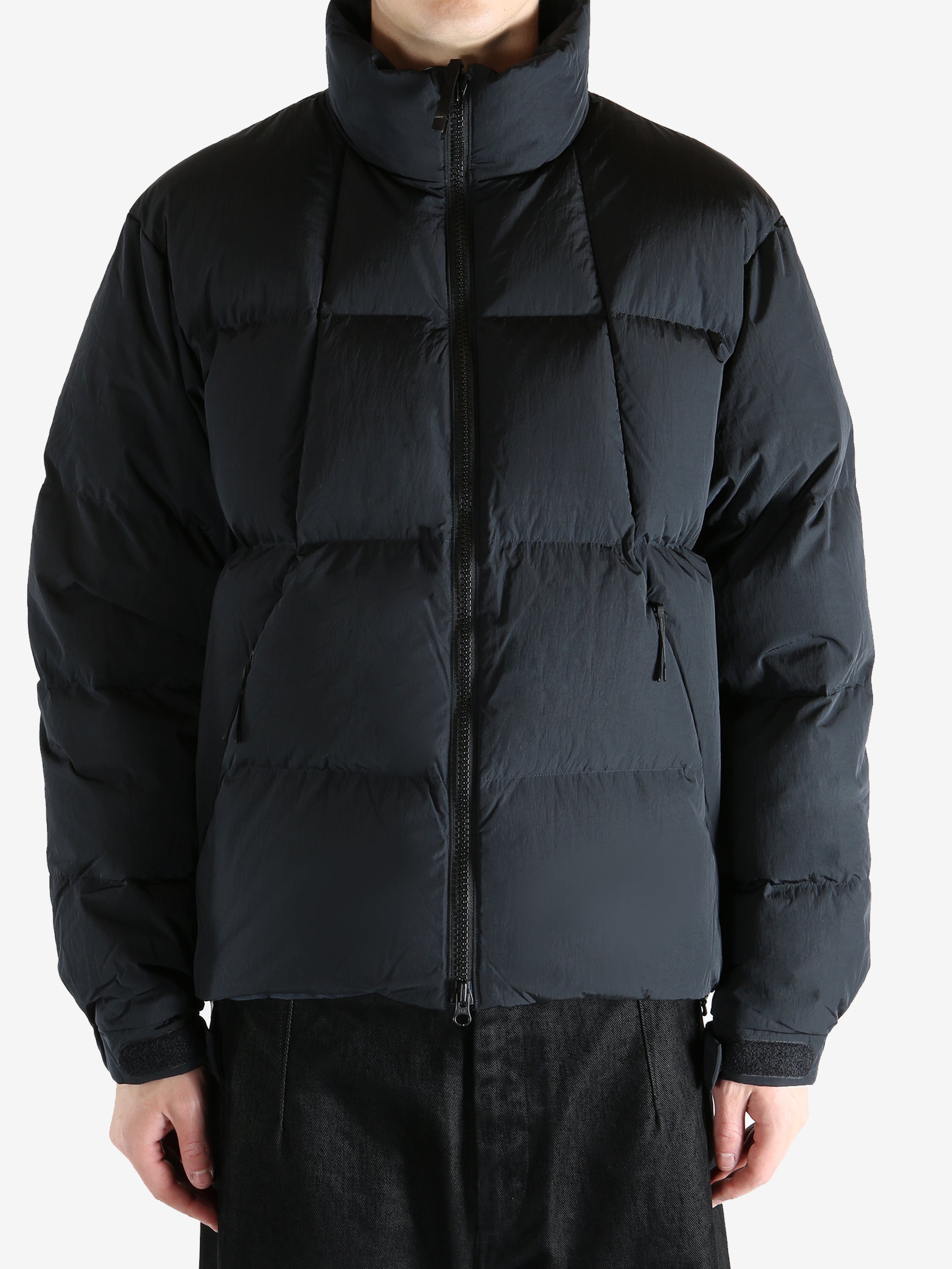 Black jacket worn by a person, showing the jacket fit