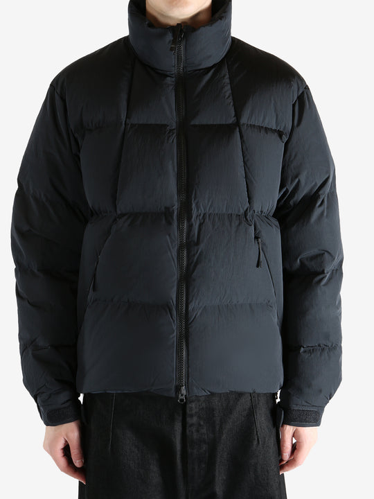 Black jacket worn by a person, showing the jacket fit