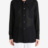 Black top worn by a person, showing the top fit