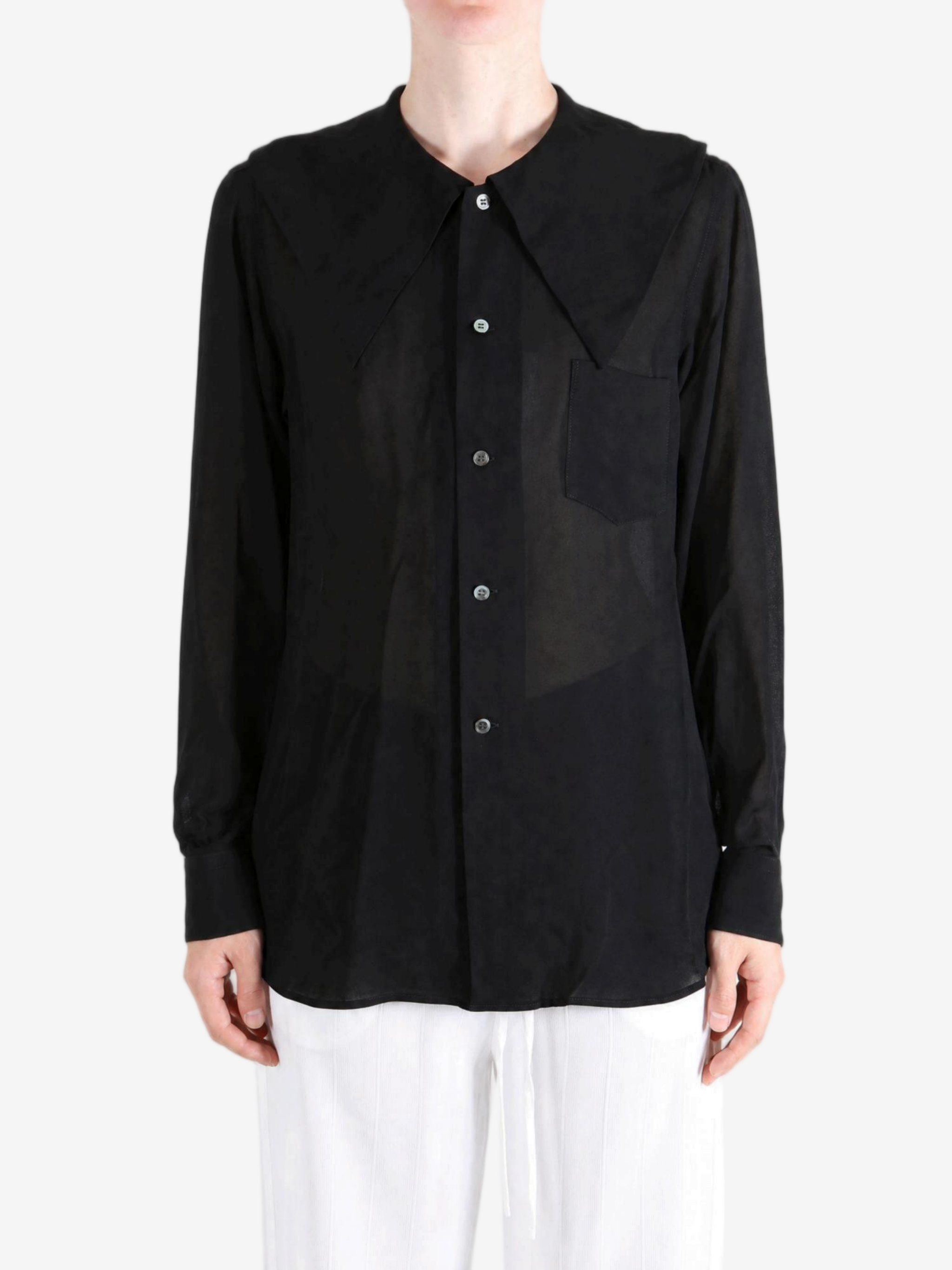 Black top worn by a person, showing the top fit
