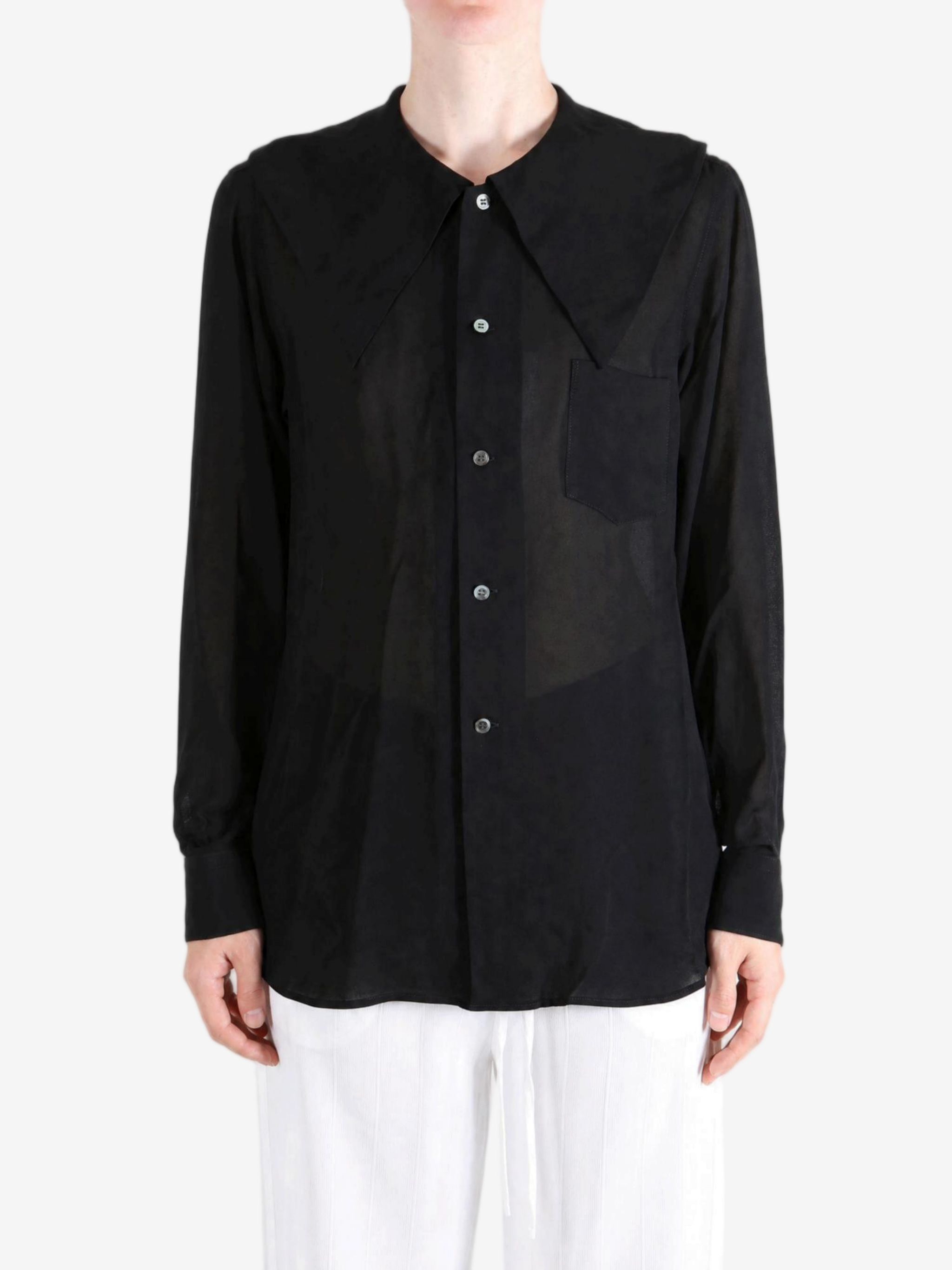 Black top worn by a person, showing the top fit