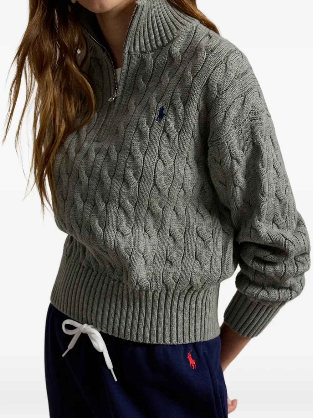 Grey knitwear worn by a person, showing the knitwear fit