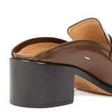 Close up of the brown mules, showing texture of the leather fabric