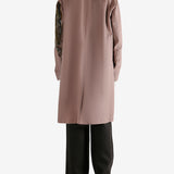 Pink coat worn by a person, showing the coat's fit