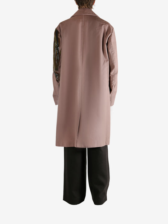 Pink coat worn by a person, showing the coat's fit