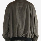 Green jacket worn by a person, showing the jacket's fit