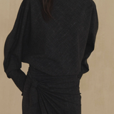 Black top worn by a person, showing the top fit