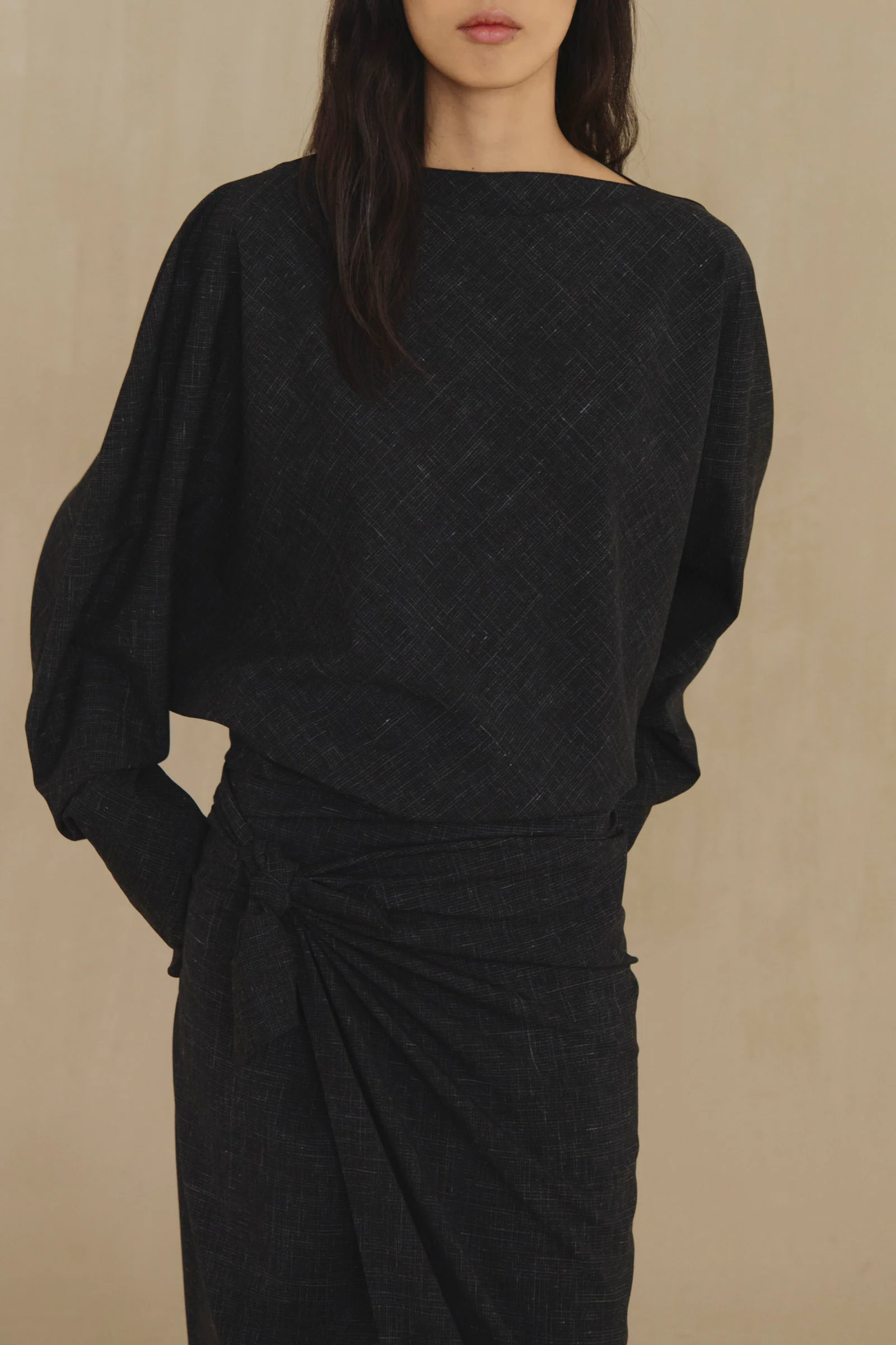 Black top worn by a person, showing the top fit