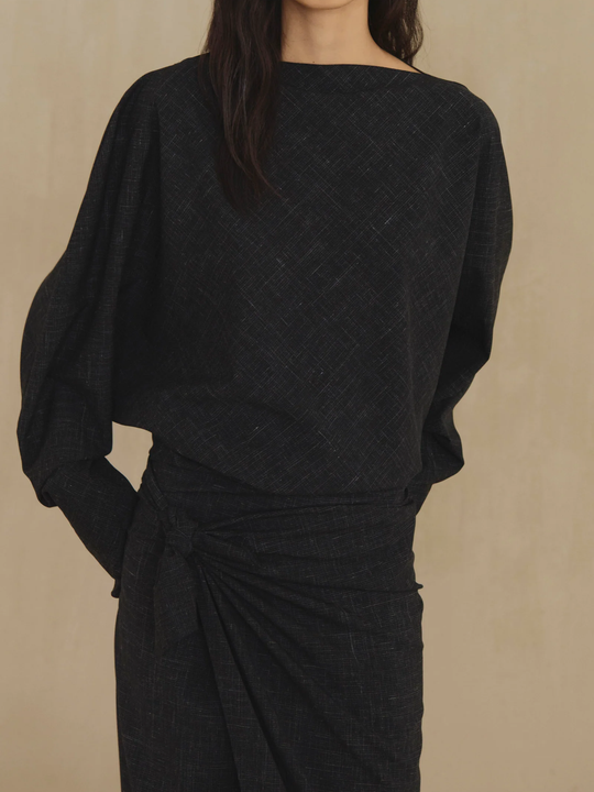 Black top worn by a person, showing the top fit
