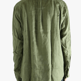 Green shirt worn by a person, showing the shirt's fit