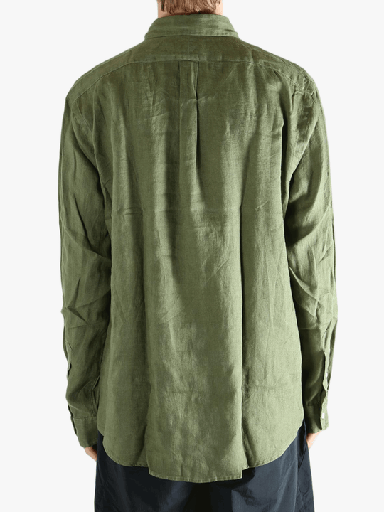 Green shirt worn by a person, showing the shirt's fit